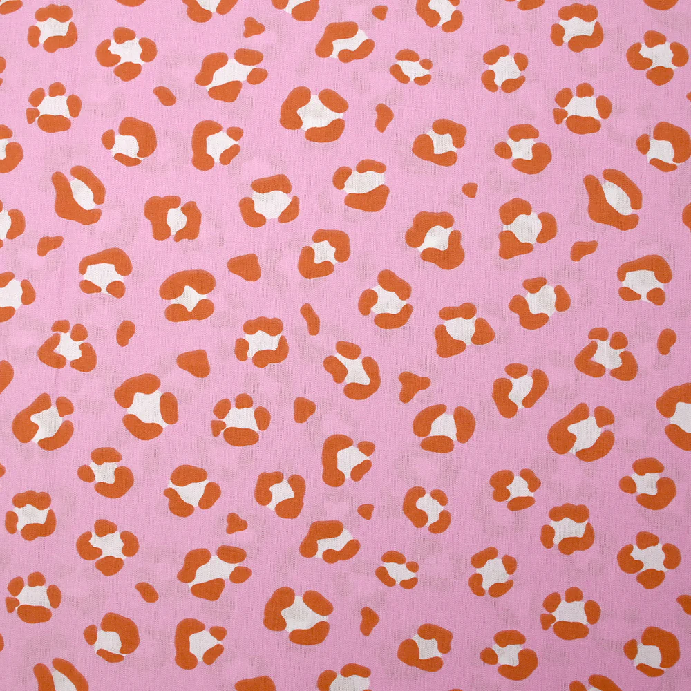 Coton imprimé léopard orange brûlé fond rose