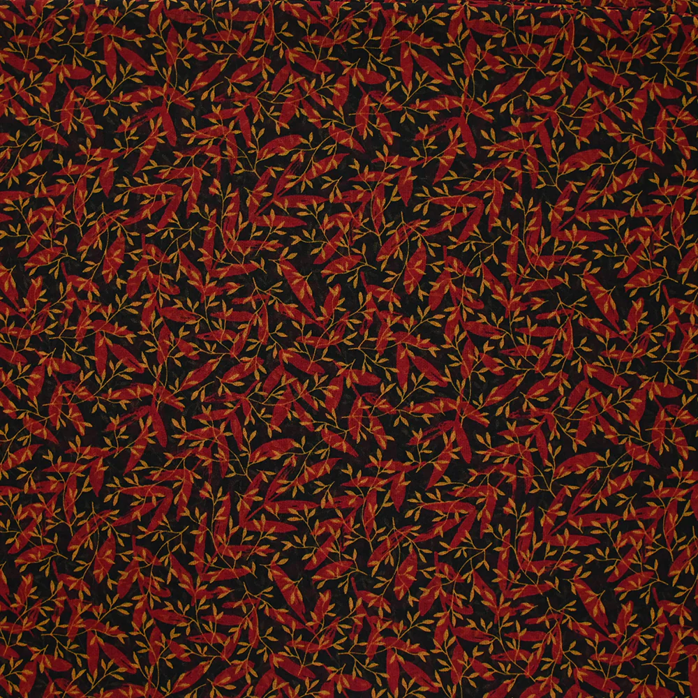 Mousseline imprimée feuilles rouge et ocre fond noir